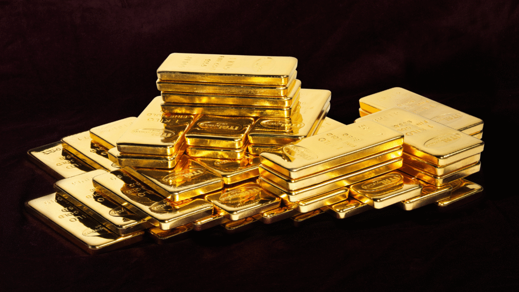 Le pile di lingotti d'oro lucidi sono disposte su una superficie scura e vellutata, che riflette la luce e mette in mostra le loro superfici lisce e lucide.