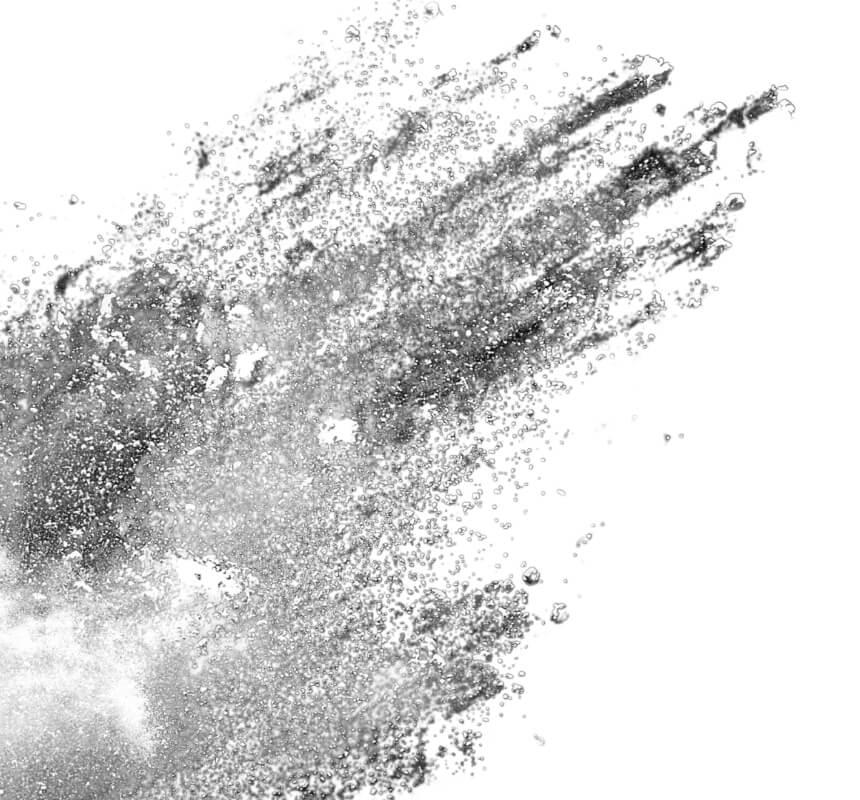 Una ráfaga de fino polvo gris se dispersa sobre un fondo blanco, creando un efecto dinámico y abstracto similar a una nube, con densidades y texturas variables.