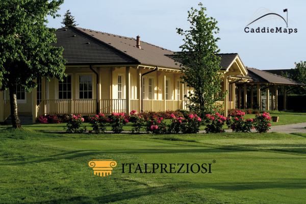 A yellow building with a covered porch and blooming pink flowers in front, set on a manicured green lawn. Logos for Italpreziosi and CaddieMaps appear on the image.