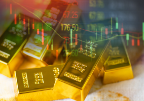 Stacks of gold bars are shown with a transparent overlay of a financial stock chart, featuring price numbers and candlestick patterns, symbolizing gold investment and market trends.