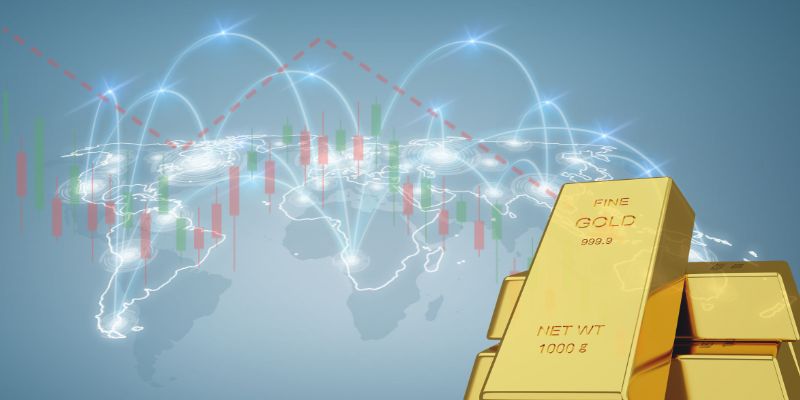 Tre lingotti d'oro in primo piano con una mappa del mondo, grafici a candela del mercato azionario, una linea rossa di tendenza al ribasso e linee curve di collegamento sullo sfondo, a rappresentare la finanza e gli investimenti globali.