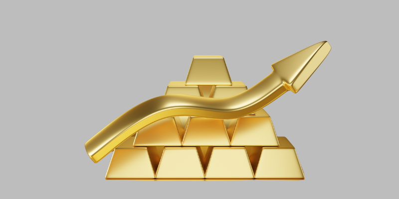 A stack of gold bars with a large, upward-pointing gold arrow curving over them, symbolizing growth or an increase in value, on a plain gray background.