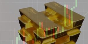 Le pile di lingotti d'oro sono mostrate con i grafici finanziari a candela sovrapposti, che illustrano l'intersezione tra l'investimento in oro e i dati di mercato.