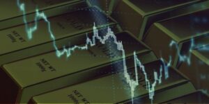 Grafico con andamento dell'oro su un background di lingotti in oro.