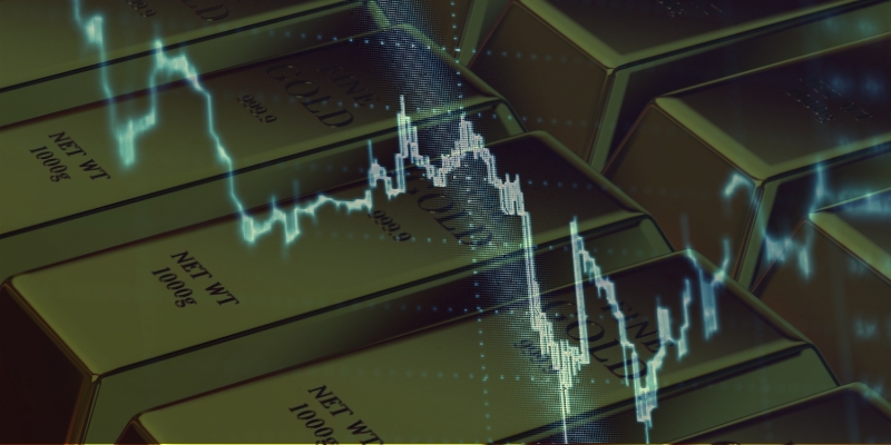 Grafico con andamento dell'oro su un background di lingotti in oro.