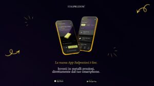 Banner promozionale Italpreziosi per il lancio della nuova app mobile. Due smartphone con cornice dorata mostrano le schermate dell'app: una pagina prodotto di un lingotto oro 500gr e una schermata di acquisto con listino di lingotti in oro e argento. In basso, testo "La nuova App Italpreziosi è live. Investi in metalli preziosi, direttamente dal tuo smartphone." con badge di download per App Store e Google Play. Sfondo blu notte con dettagli grafici dorati.